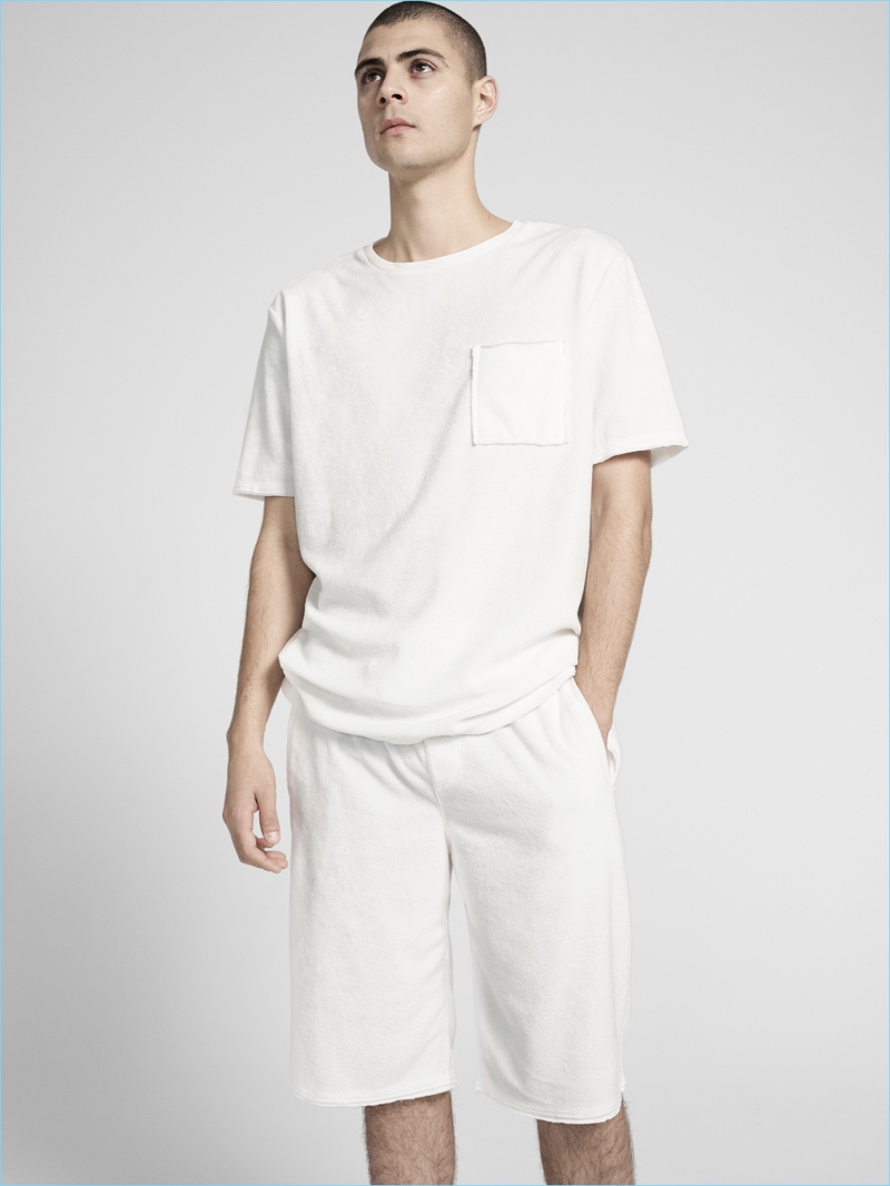 Making a monochromatic statement, Micky Ayoub wears a white pocket tee and shorts by ATM.