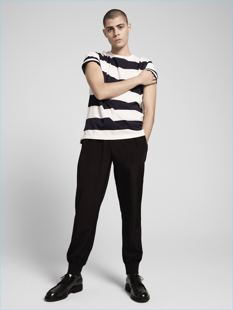 Going casual, Micky Ayoub sports a striped black and white t-shirt with joggers by ATM.