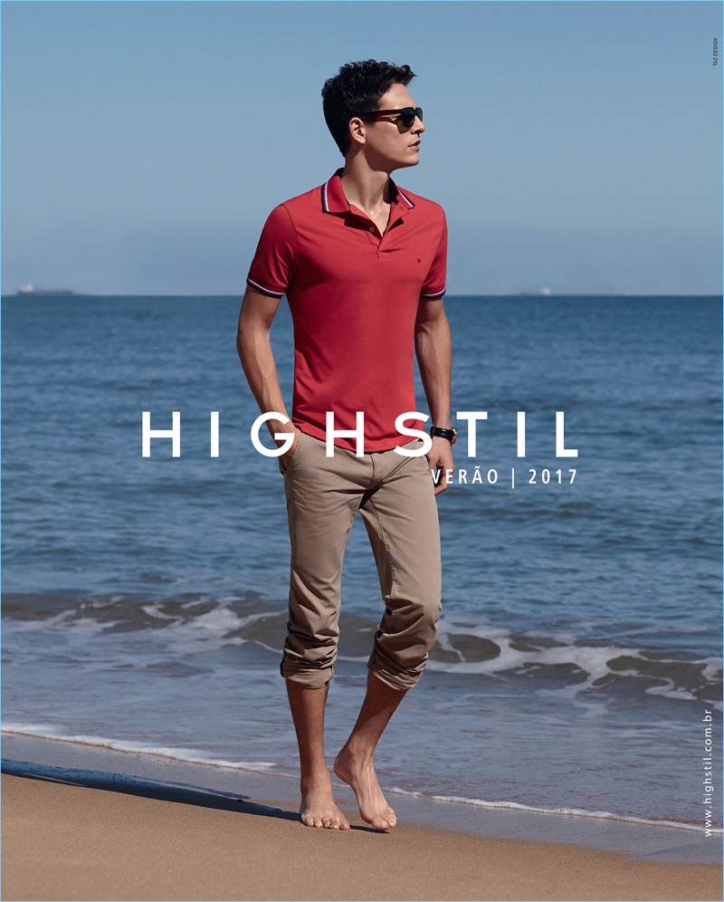 Taking to the beach for Highstil's spring-summer 2017 campaign, Alexandre Cunha wears a red polo shirt with casual slim-fit pants.