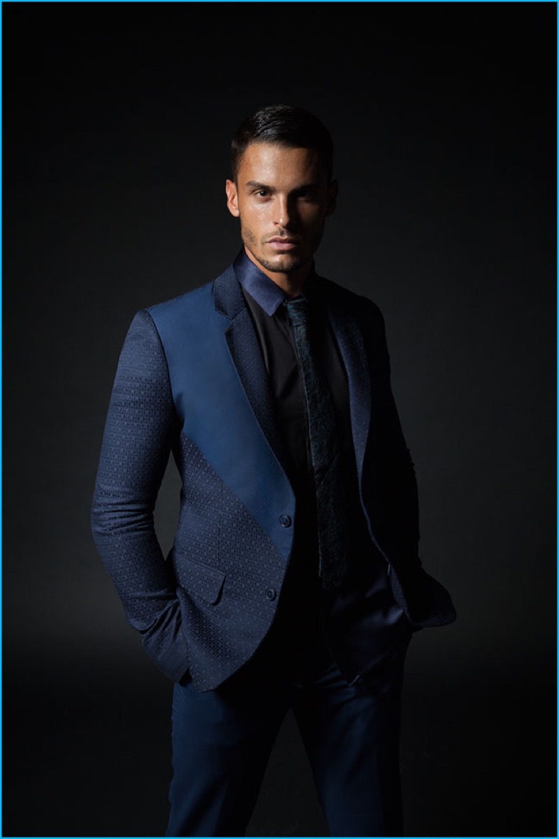 Model Baptiste Giabiconi makes a sleek impression in a navy suit by Monlada Homme.