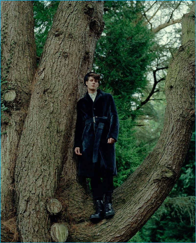 Model Marc André Turgeon wears a chic belted coat by Louis Vuitton.