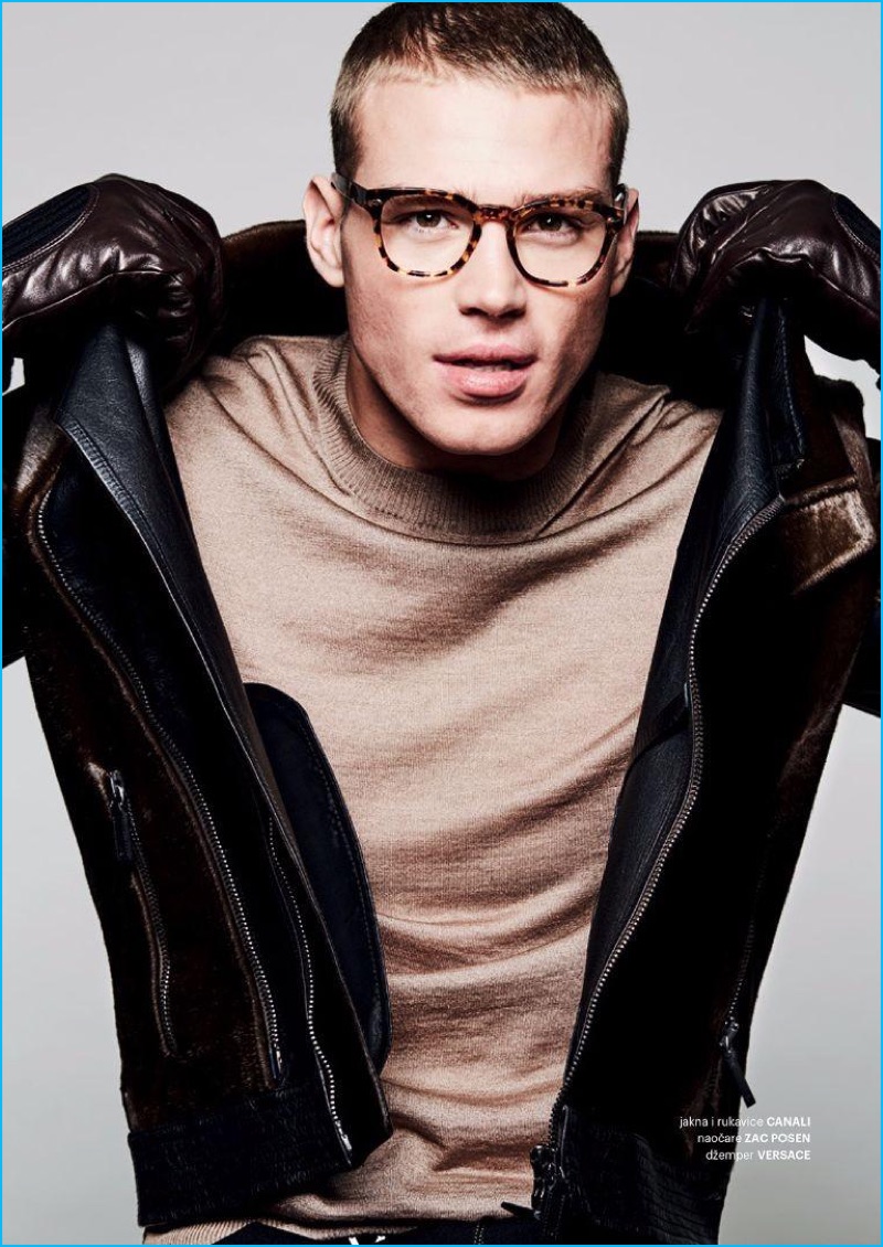 Matthew Noszka rocks a jacket and gloves by Canali with a Versace sweater and Zac Posen tortoiseshell glasses.