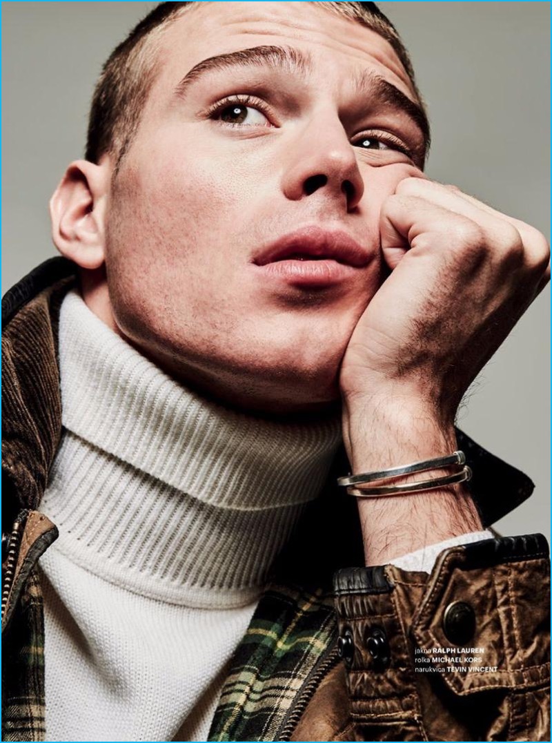 Sitting for a portrait, Matthew Noszka dons a Ralph Lauren leather jacket with a Michael Kors turtleneck sweater, and Tevin Vincent bracelet.