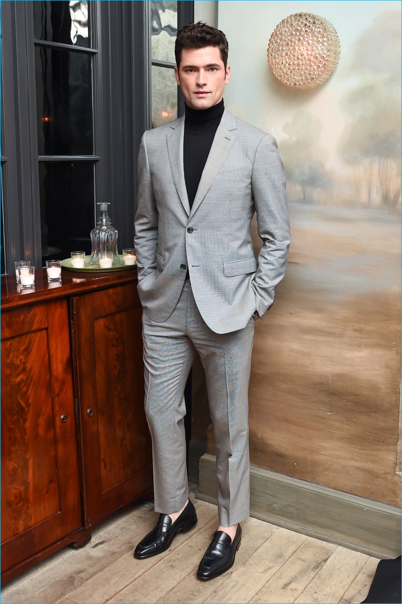 American model Sean O'Pry cleans up in a light grey suit with a black turtleneck by Salvatore Ferragamo. 