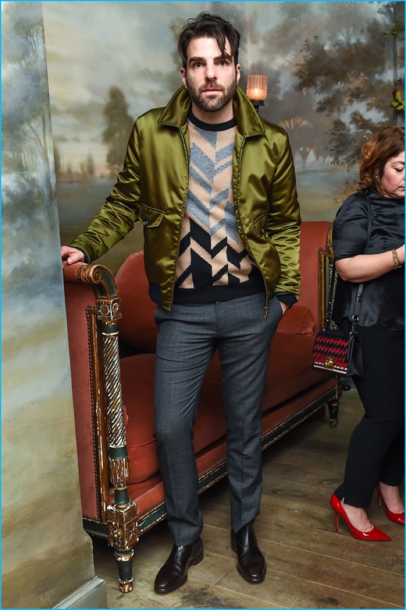 Zachary Quinto makes a style statement in a chevron sweater and satin jacket.