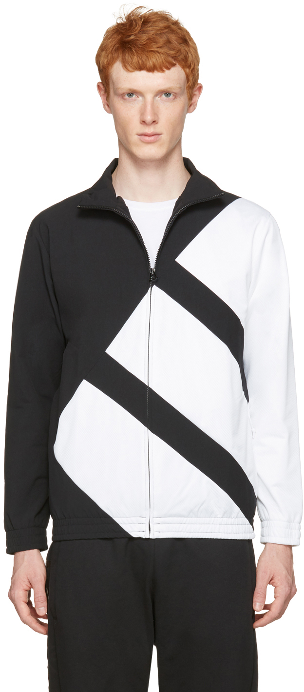 Long sleeve nylon satin and mesh track jacket colorblocked in black and white. Stand collar. Zip closure at front. Zippered seam pockets at waist. Elasticized cuffs and hem. Mesh lining. Tonal hardware. Tonal stitching. Body: 90% nylon, 10% elastane. Trim: 100% polyester. Lining: 100% polyester.