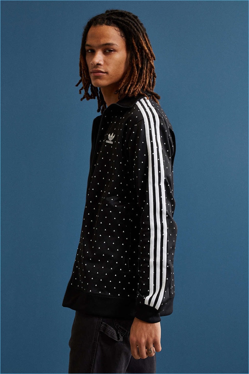 Pharrell Williams puts his spin on the classic track jacket from adidas. Zip-front silhouette in a mini triangle print features woven three-stripes down both sleeves and rib-knit banding at the collar, cuffs + hem for a perfect fit. Finished with an embroidered trefoil logo at the chest and two zip pockets at the waist. One of the foremost sportswear labels worldwide, adidas combines fashion and function to create a classically technical range of sneakers and athletic wear.