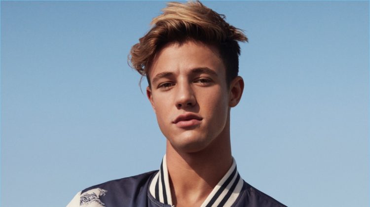 Cameron Dallas rocks a trendy bomber jacket with a palm tree print for American Eagles Outfitters' spring 2017 campaign.
