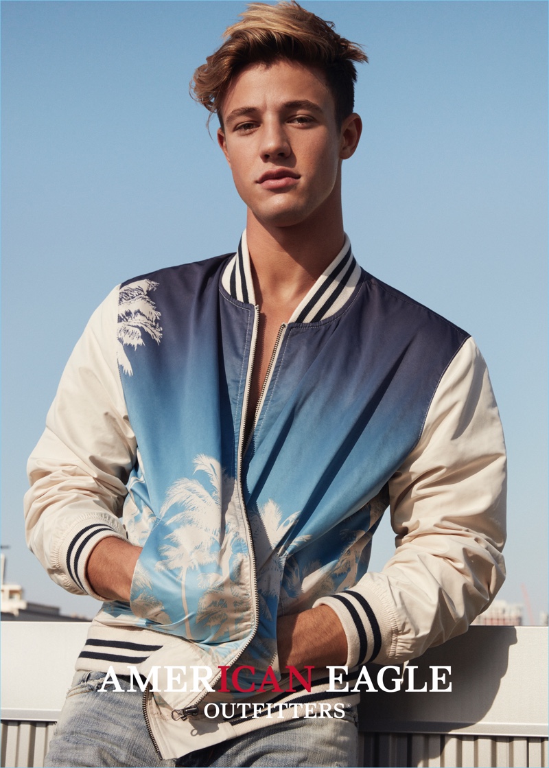 Cameron Dallas rocks a trendy bomber jacket with a palm tree print for American Eagles Outfitters' spring 2017 campaign.