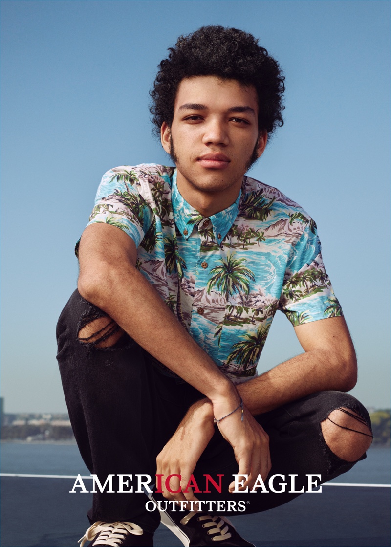 Justice Smith wears ripped denim jeans and a Hawaiian shirt for American Eagle Outfitters' spring 2017 campaign.