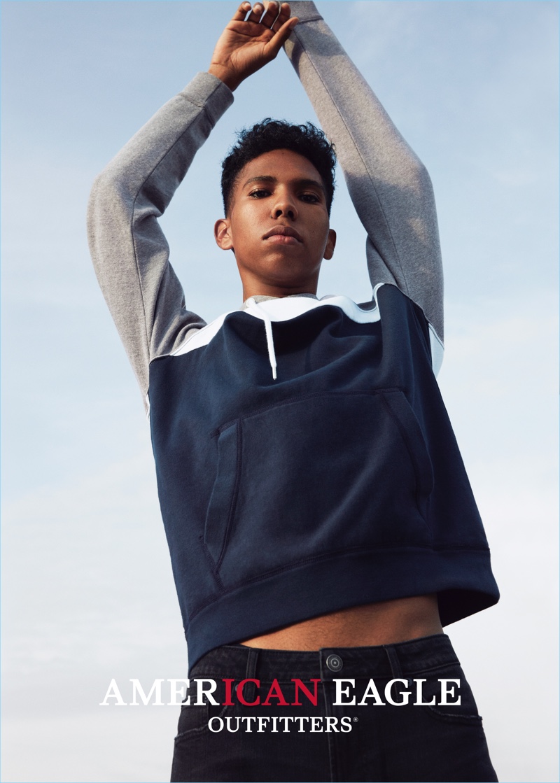Tyler Mitchell goes sporty in a color blocked hoodie and denim jeans for American Eagle Outfitters' spring 2017 campaign.