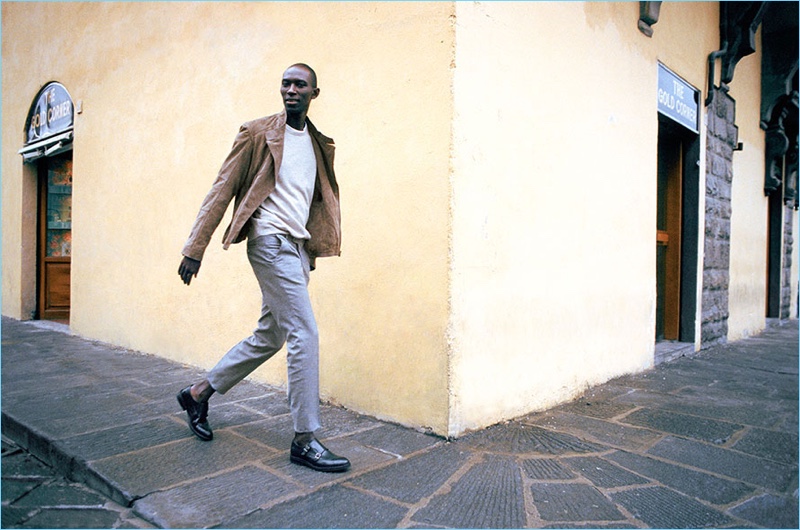 Embracing chic style, Armando Cabral dons a biker-style suede jacket with a cashmere sweater and slim-fit trousers from Massimo Dutti.