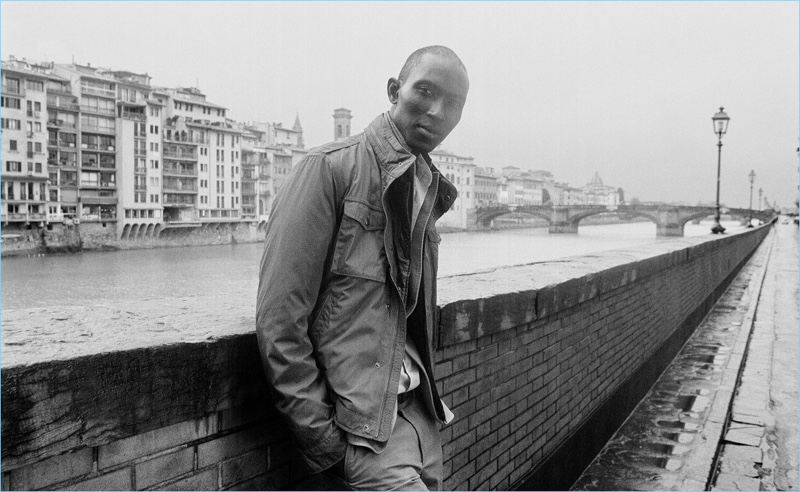 Model Armando Cabral sports a technical jacket, linen blazer, and chinos by Massimo Dutti.