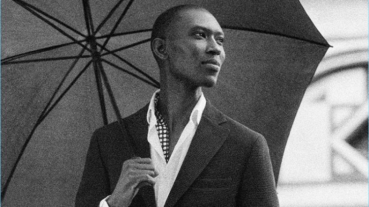 A sleek vision, Armando Cabral dons a wool and cotton blend blazer with a stretch shirt, printed linen scarf, and jogging-style trousers from Massimo Dutti.