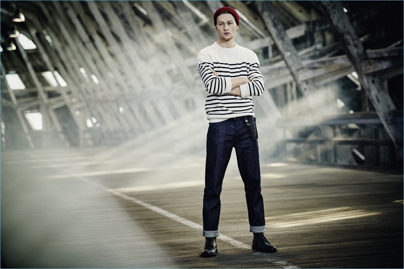 A casual vision, Bastian Thiery models a Breton stripe sweater with dark indigo jeans from Belstaff.
