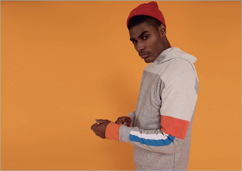 Tapping into a retro energy, Karon Byers rocks a colorful hoodie from BoohooMan's spring-summer 2017 collection.