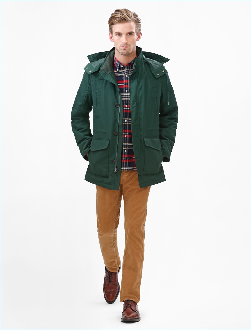 American model RJ King goes casual in a plaid button-down shirt and parka from Brooks Brothers Red Fleece's fall-winter 2017 collection.