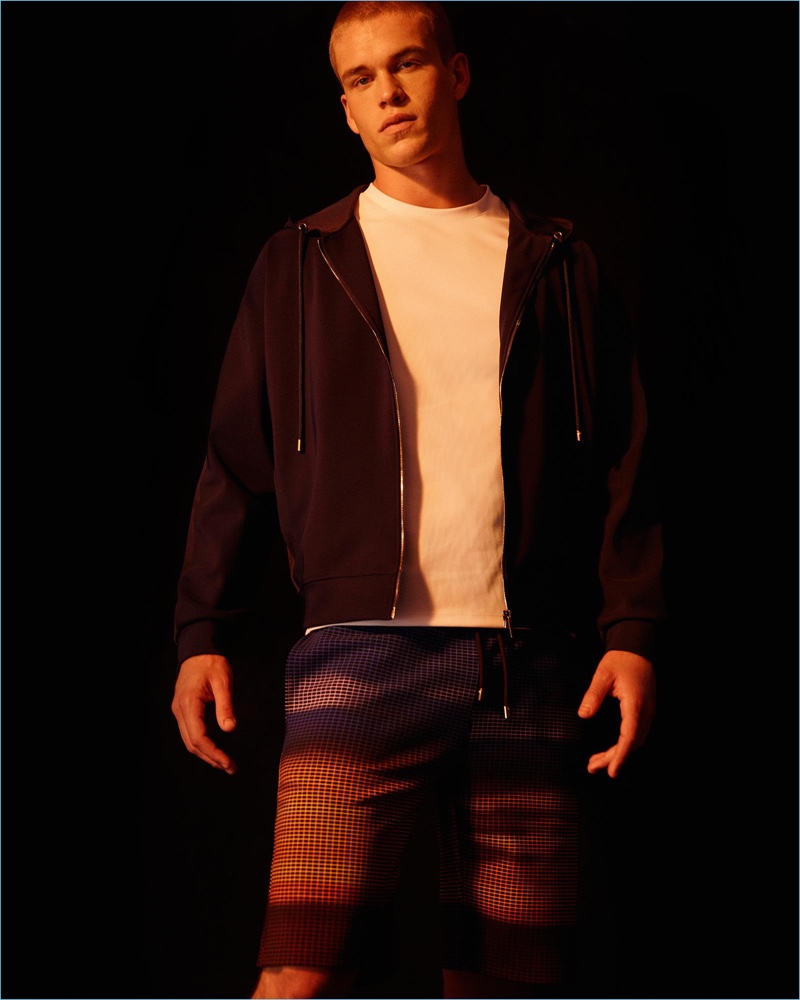 Front and center, Mitchell Slaggert sports a hoodie and graphic pants from Calvin Klein Collection.