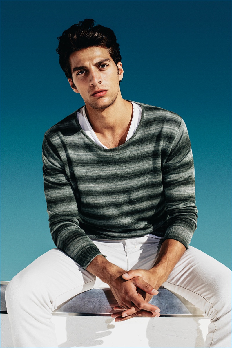 Going casual, Simone Susinna wears a lightweight striped knit with white jeans from CINQUE.