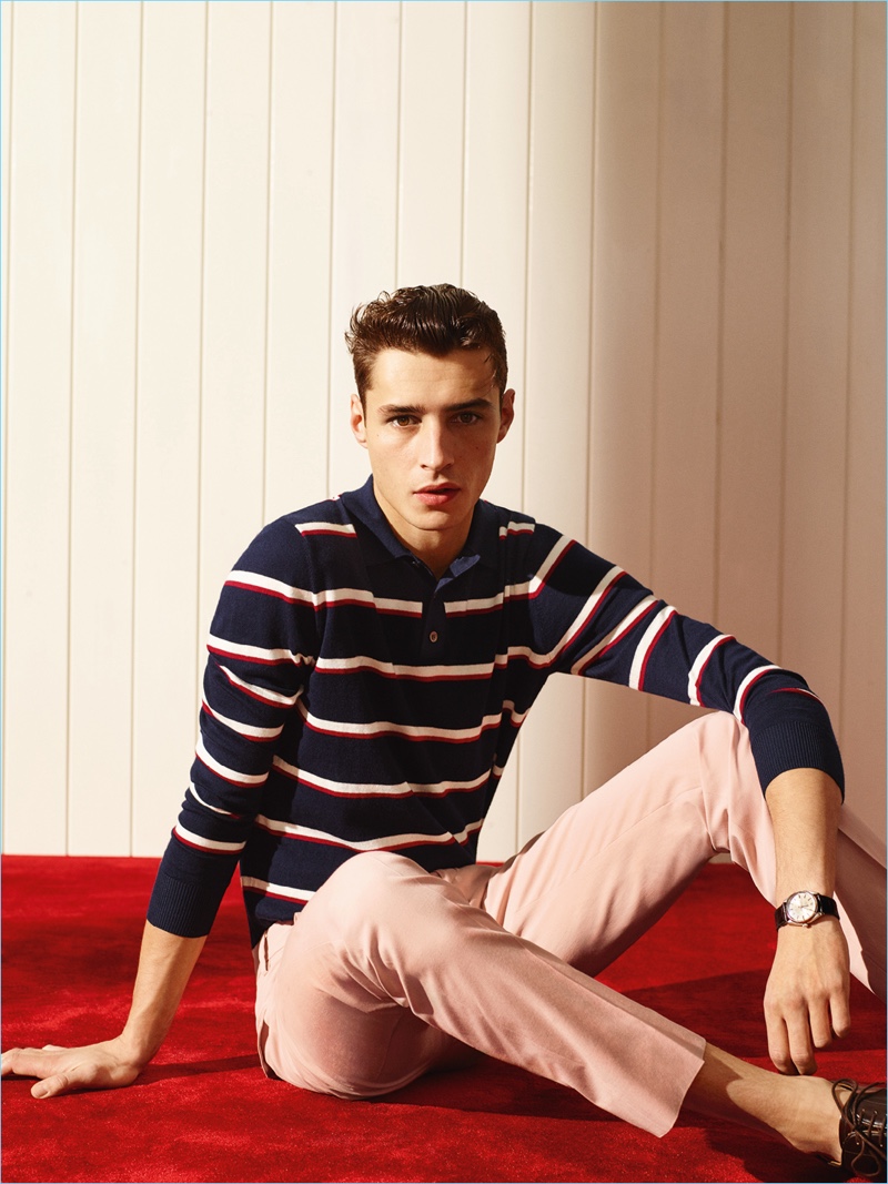 Karim Sadli photographs Adrien Sahores in a striped red, white and navy blue long-sleeve polo shirt.