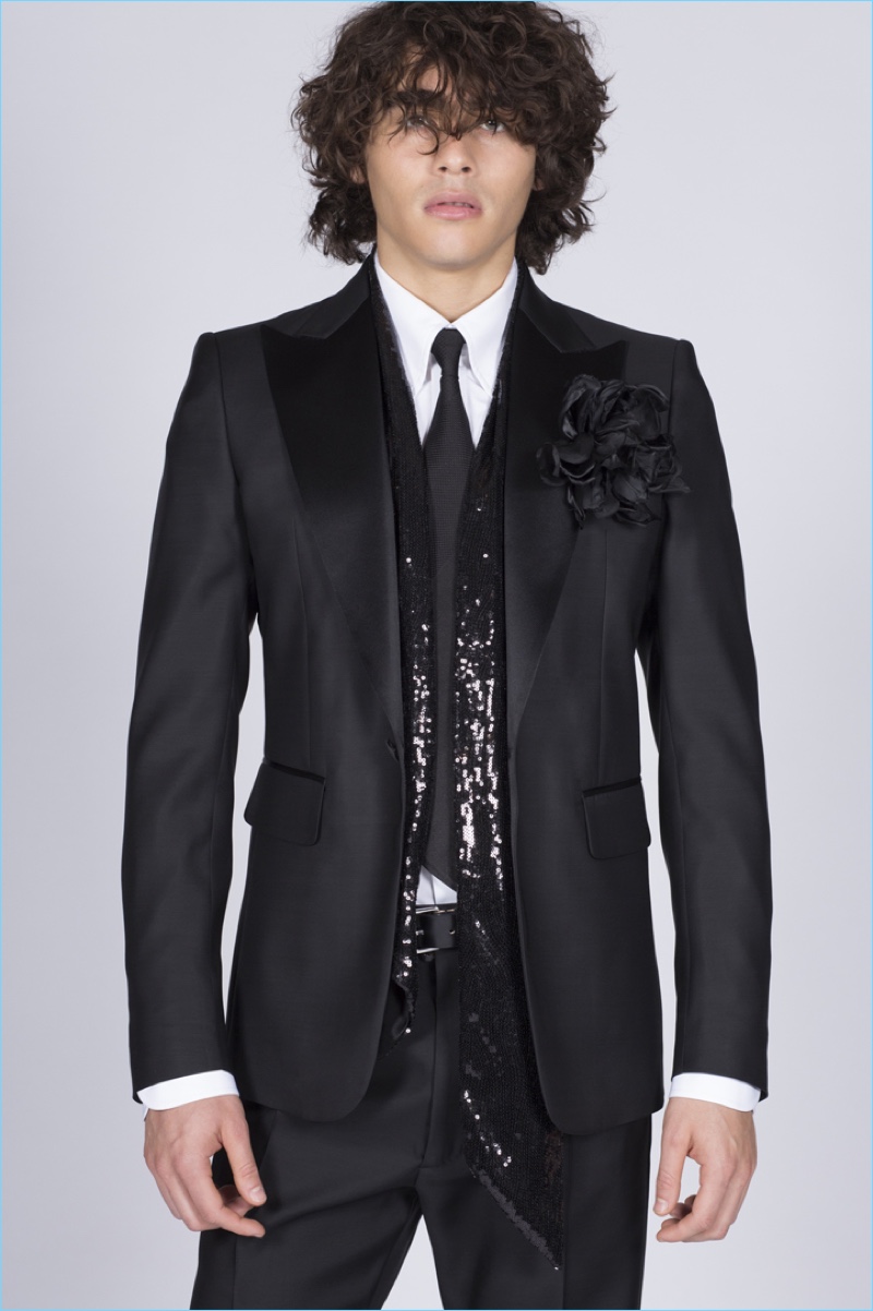 Model Francisco Perez is glam in a black tuxedo with a sequined scarf from Dsquared2.