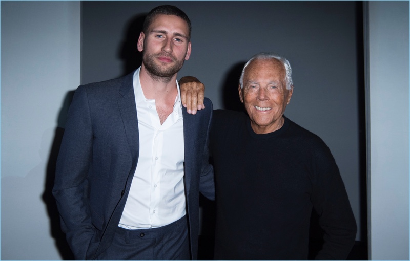 Actor Edward Holcroft poses for pictures with Giorgio Armani.