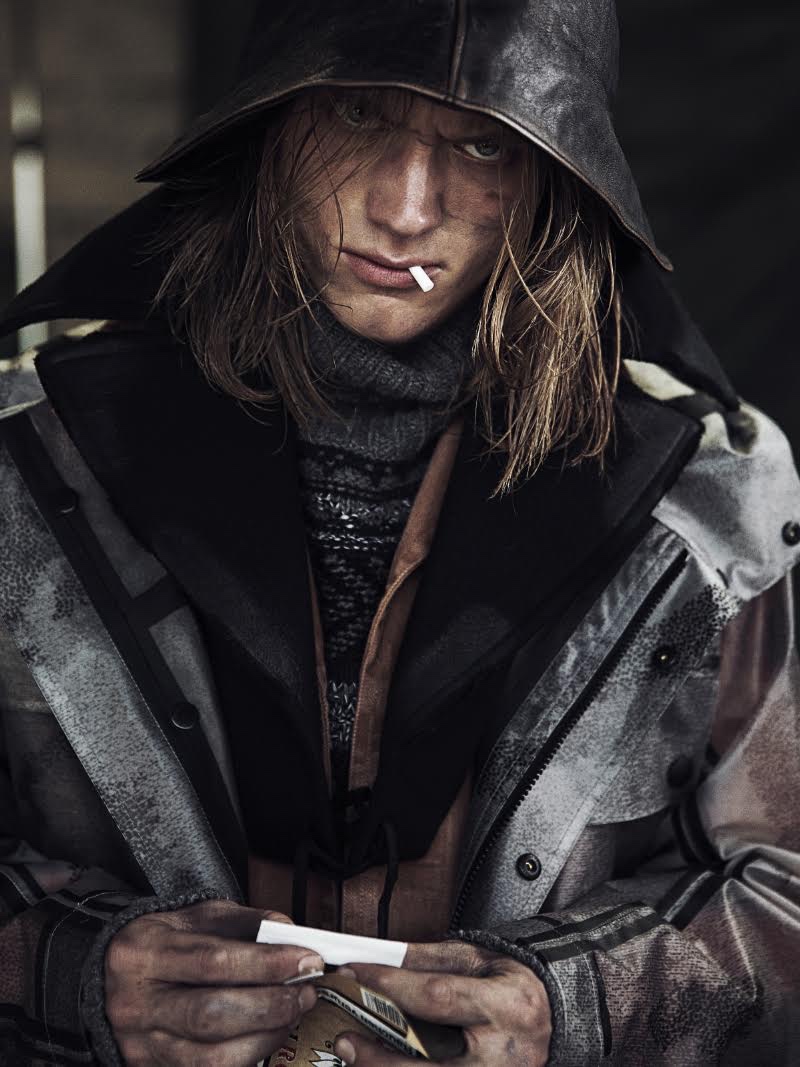 Enzo wears brown denim coat Prada, grey hooded coat and turtleneck Belstaff.