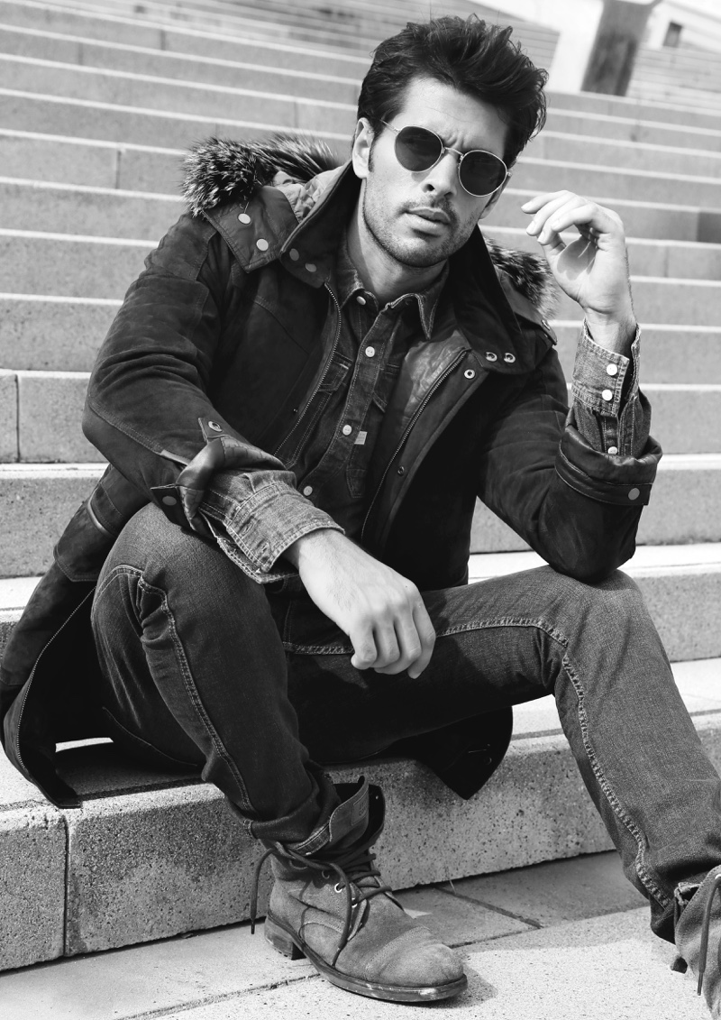 Raul wears denim shirt G-Star Raw, distressed denim jeans GUESS, jacket Torras, boots Replay, and aviator sunglasses Ray-Ban.