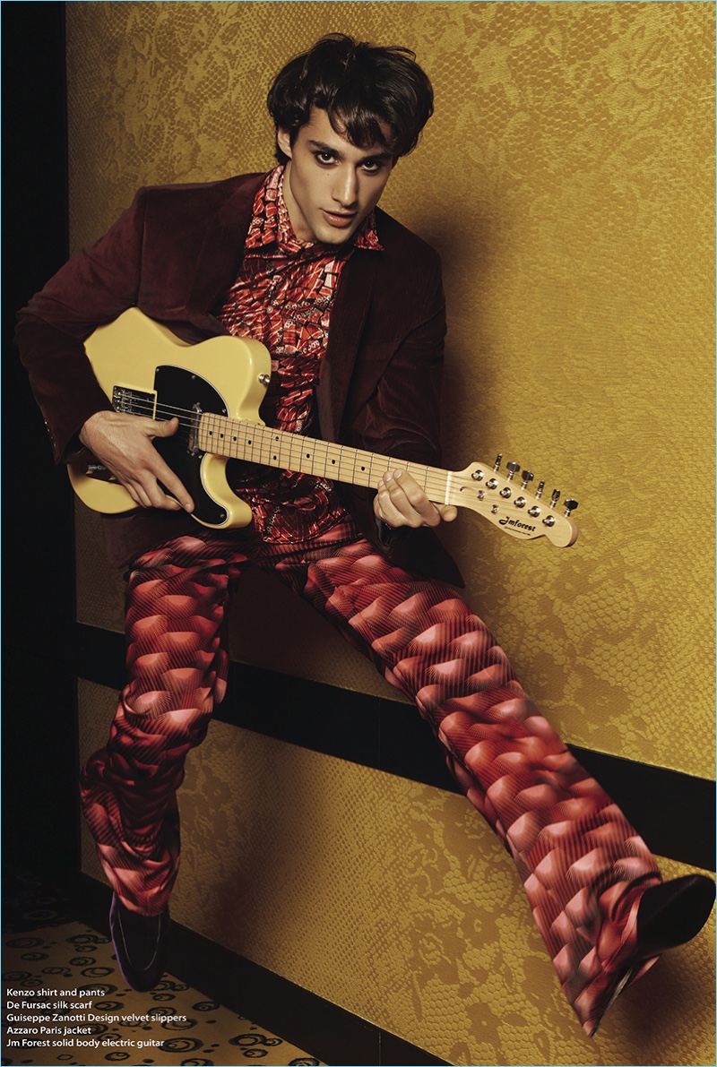 Embracing psychedelic style, Felix Cordier wears a Kenzo shirt and pants. Felix also rocks a De Fursac silk scarf, an Azzaro jacket, and Giuseppe Zanotti velvet slippers. 