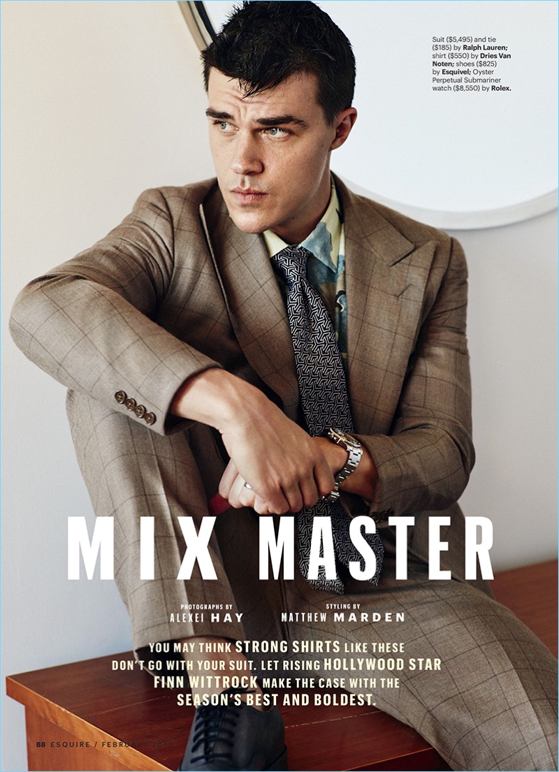 Appearing in a stylish photo shoot for Esquire, Finn Wittrock dons a Ralph Lauren windowpane suit and graphic tie. The actor also sports a Dries Van Noten shirt, Rolex watch, and Esquivel dress shoes.