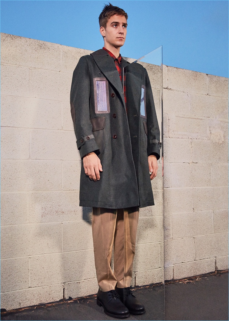 Appearing in a style edit for Forward, Samuel Roberts wears a Junya Watanabe solar panel coat with 3.1 Phillip Lim classic tapered trousers. Samuel also sports a red and black button-down shirt with leather dress shoes by Ann Demeulemeester.