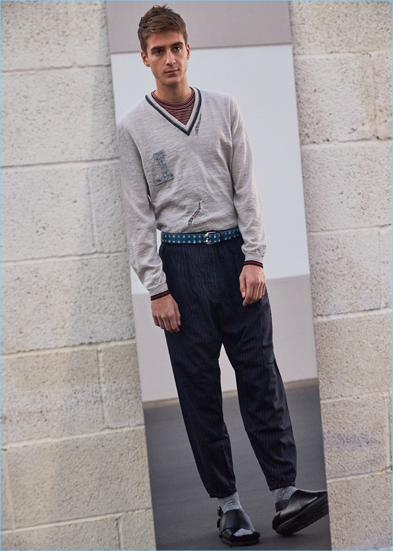 Model Samuel Roberts rocks a Lanvin v-neck sweater and micro-stripes tee with Engineered Garments trousers. Samuel completes his look with Marni fur sandals and an Alexander McQueen belt.