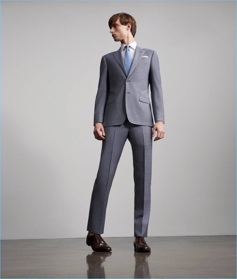 A sharp vision, Laurie Harding dons a suit by Giorgio Armani.