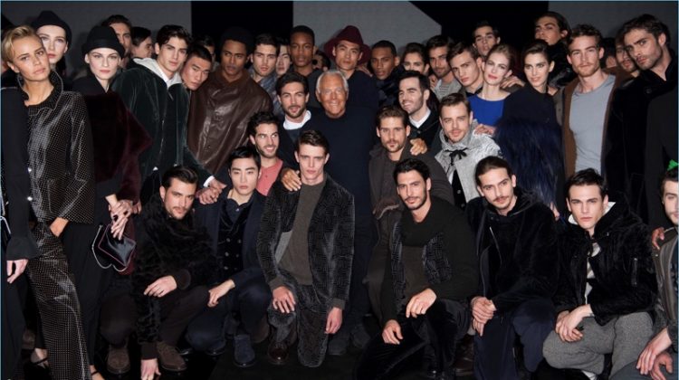 Giorgio Armani poses for pictures with the models who walked his namesake show for fall-winter 2017.