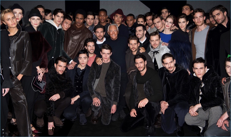 Giorgio Armani poses for pictures with the models who walked his namesake show for fall-winter 2017.