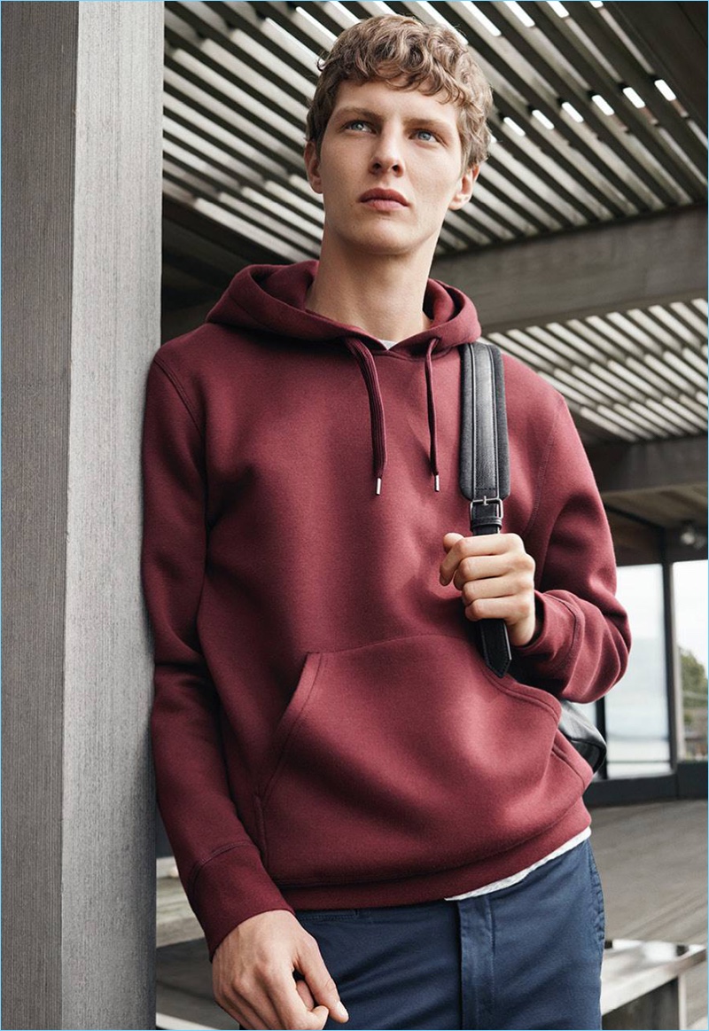 Going casual, Tim Schuhmacher rocks a hooded sweatshirt with cotton twill pants.