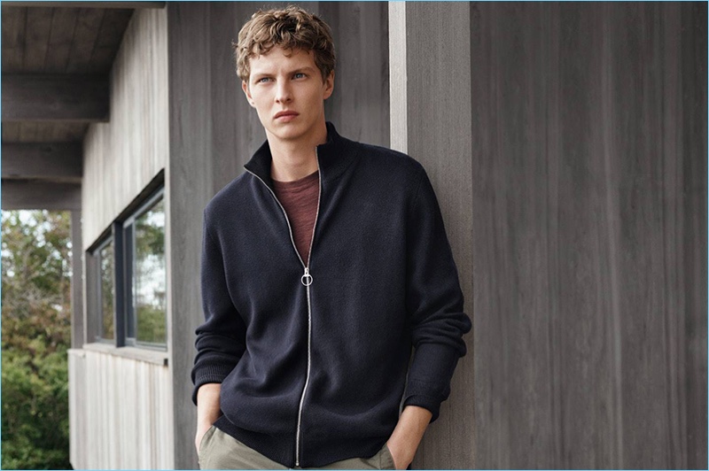 Tim Schuhmacher wears a full-zip cardigan sweater with a t-shirt and slim-fit pants.