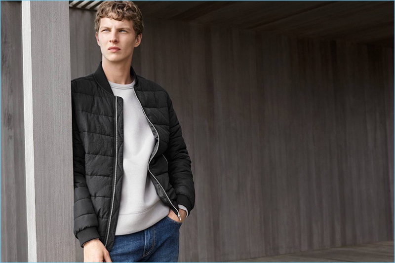 Tim Schuhmacher wears a padded bomber jacket with a sweatshirt and denim jeans from H&M.