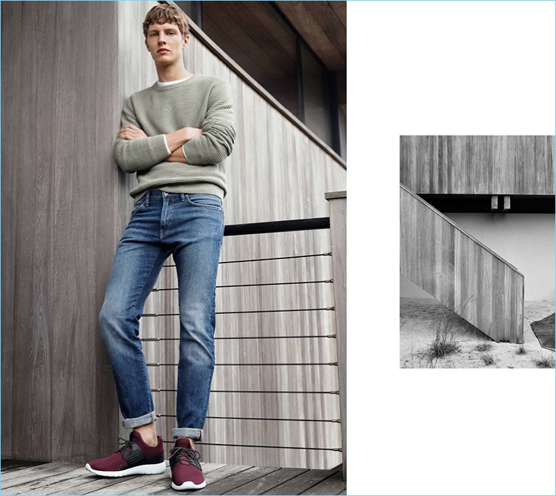 Wearing the latest from H&M, Tim Schuhmacher sports a slim-fit jeans with a sweater and sneakers.