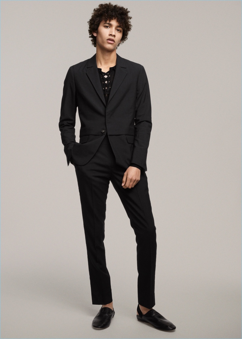 Jackson Hale wears a black lace-up top and black tailored suit from H&M Studio's spring-summer 2017 men's collection.