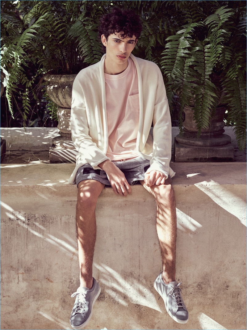 Piero Mendez dons a pale pink pocket tee with a cardigan and shorts by John Elliott. » John Elliott Brings a Pop of Color with Season 9 Drop Piero Mendez dons a pale pink pocket tee with a cardigan and shorts by John Elliott.
