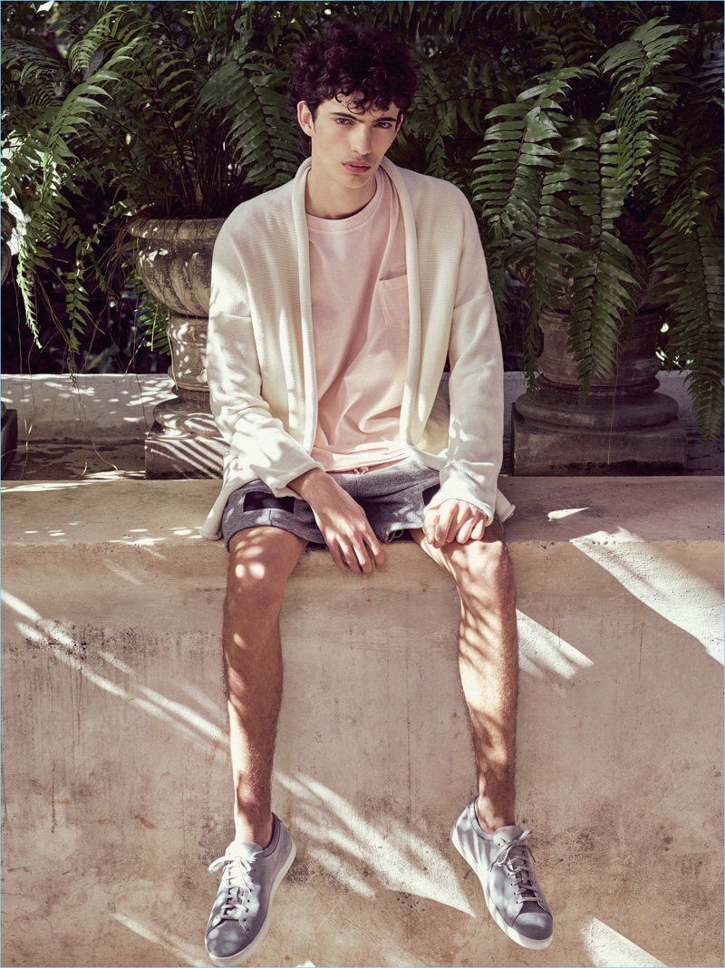 Piero Mendez dons a pale pink pocket tee with a cardigan and shorts by John Elliott.