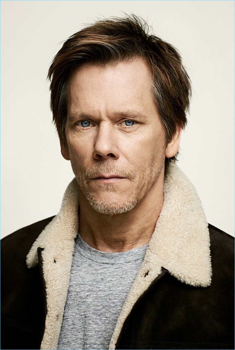 Front and center, Kevin Bacon wears a Tom Ford shearling trimmed suede jacket and cashmere-blend t-shirt.