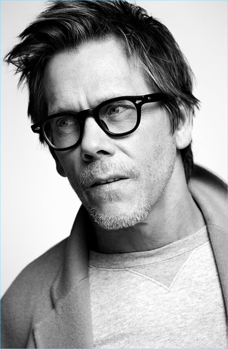 Wearing everyday essentials, Kevin Bacon dons an Acne Studios overcoat and Neighborhood sweatshirt.