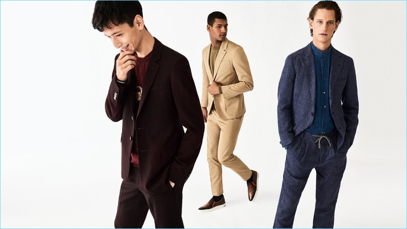 Suit up for spring with a flair for color. Left to Right: Hideki Asahina wears a burgundy suit and sweater by Lanvin. Tidiou M'Baye dons a beige Berluti suit and sweater. Rogier Bosschaart models a linen Brunello Cucinelli suit and chambray granddad collar shirt.