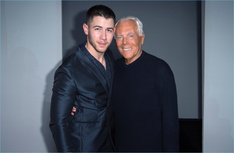 Nick Jonas poses for pictures with Giorgio Armani.