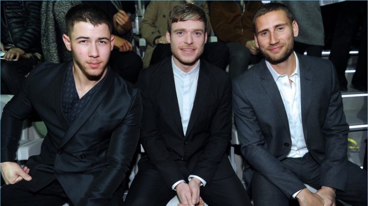 Nick Jonas, Richard Madden, and Edward Holcroft sit front row at Emporio Armani's fall-winter 2017 show.