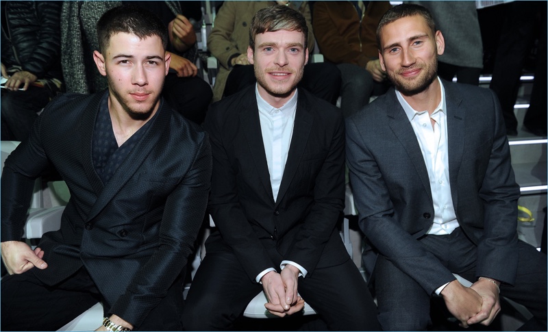 Nick Jonas, Richard Madden, and Edward Holcroft sit front row at Emporio Armani's fall-winter 2017 show.