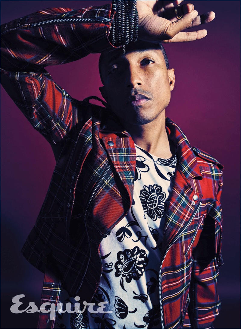 Pharrell dons a plaid biker jacket by Black Comme des Garçons with a graphic Junya Watanabe t-shirt.