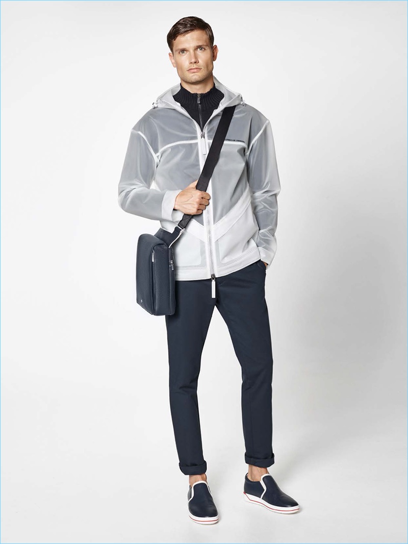 Turn heads in Porsche Design's layered jacket. Here, the statement piece is styled with cotton blend pants, slip-on sneakers, and a shoulder bag.